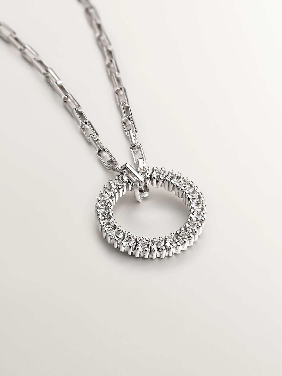 925 Silver pendant with circle of white topazes.