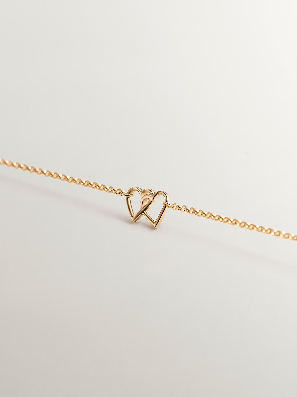 9K Yellow Gold bracelet with interlaced hearts
