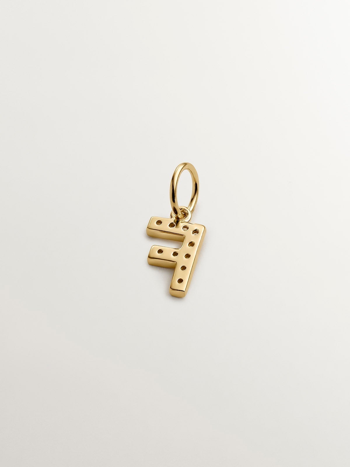 F initial charm made of 925 silver, bathed in 18K yellow gold with white topazes.