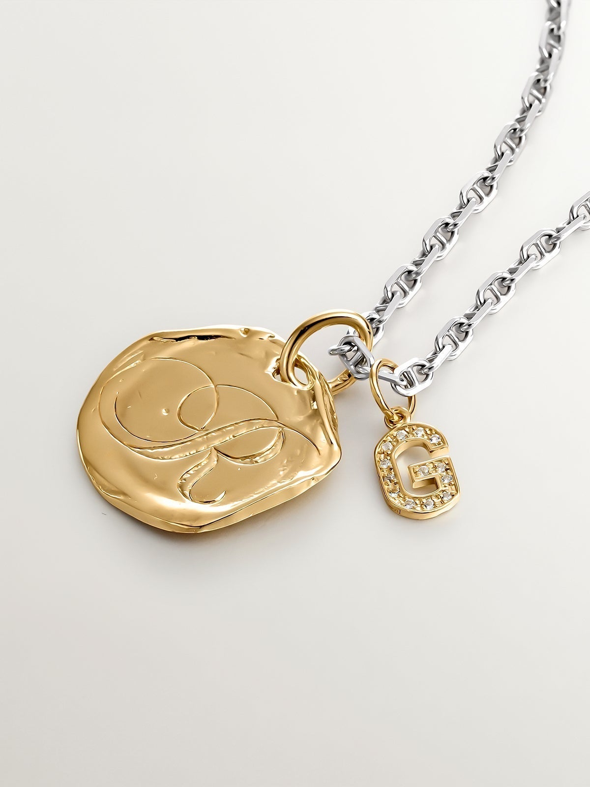 Charm made of 925 silver, bathed in 18K yellow gold and white topaz with the initial G.