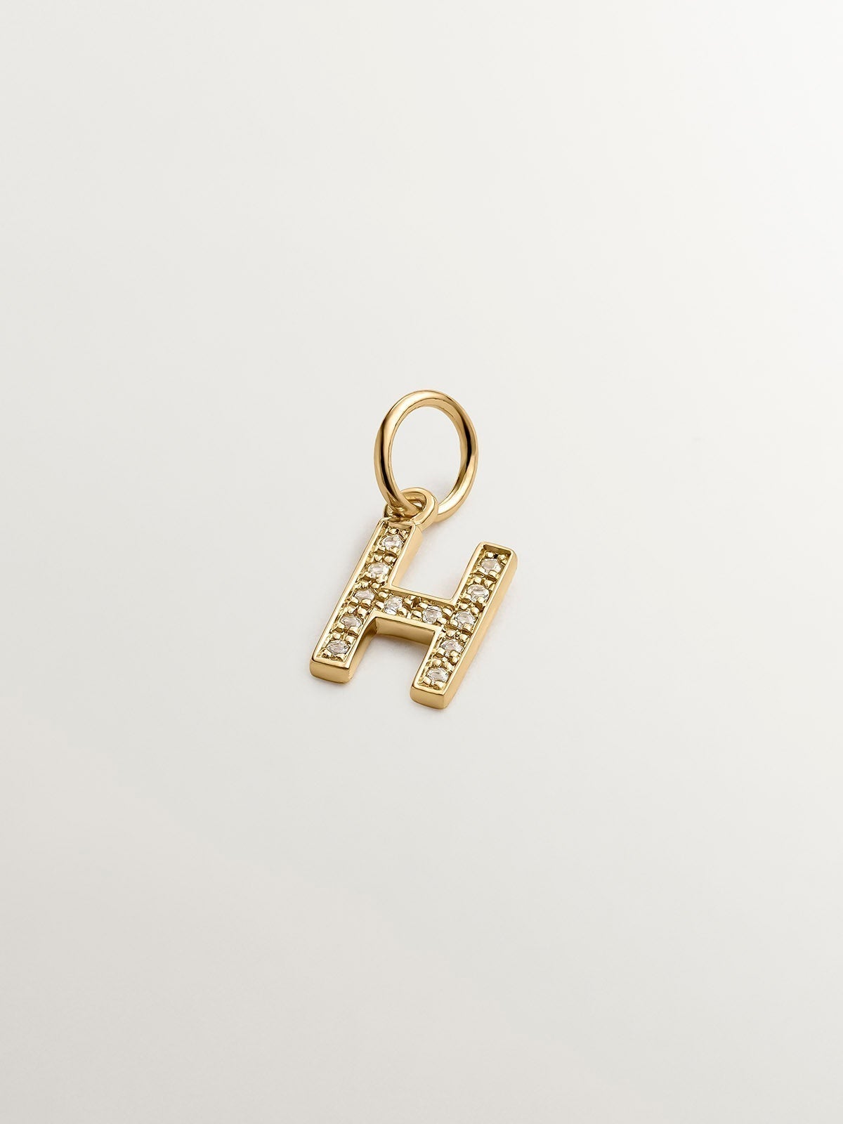 925 Silver charm bathed in 18K yellow gold and white topazes initial H.