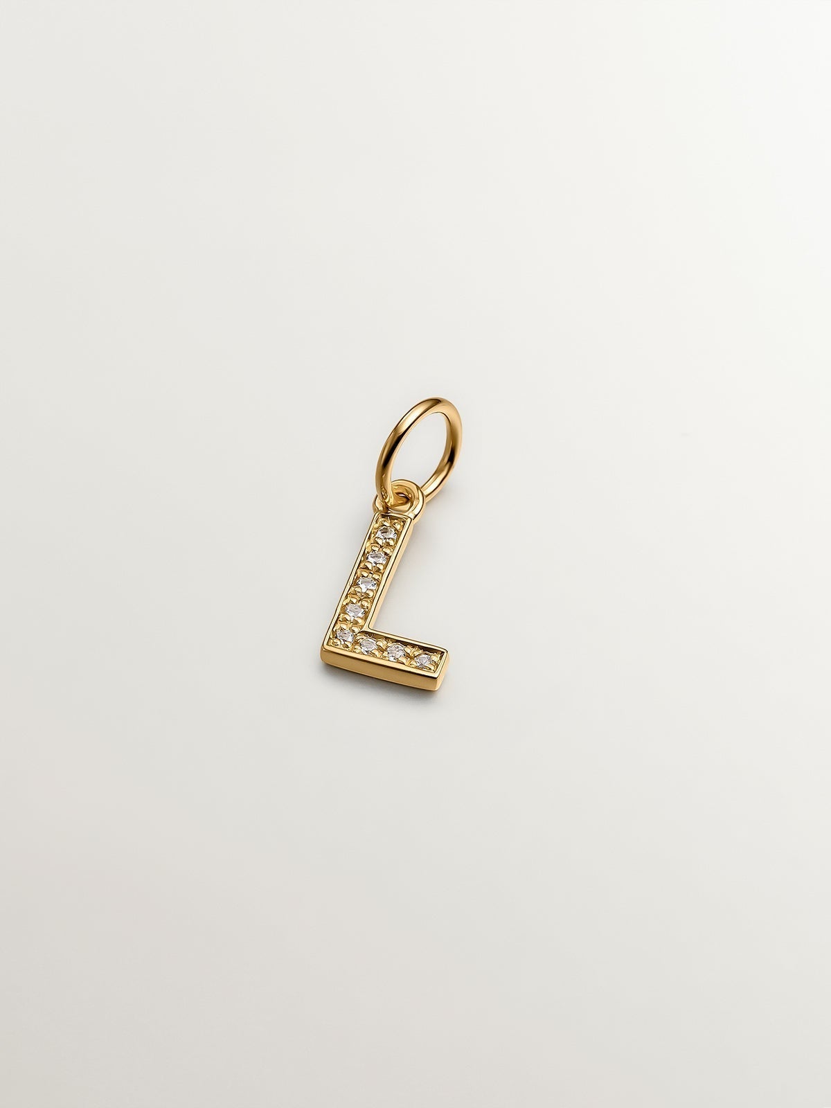 925 Sterling silver charm bathed in 18K yellow gold and white topaz with the initial L.