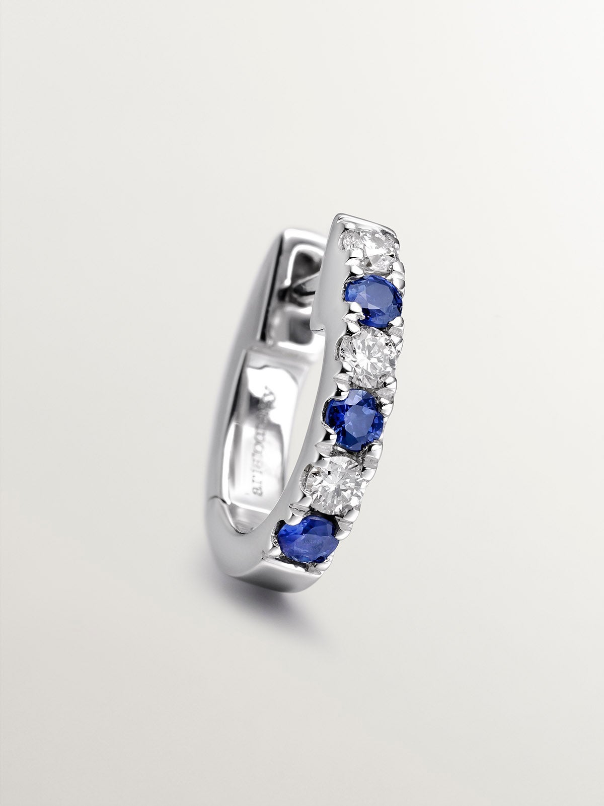 Individual small 9K white gold hoop earring with blue sapphires and diamonds