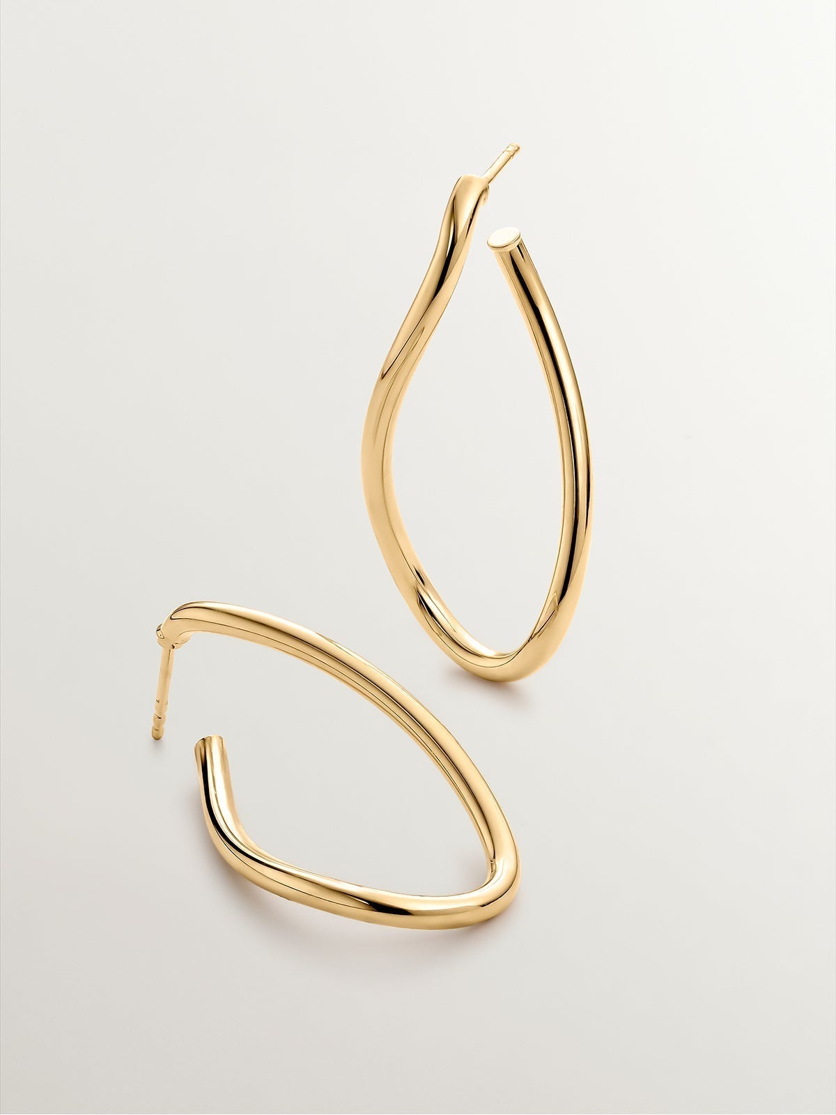 Large wavy hoop earrings made of 925 silver plated in 18K yellow gold