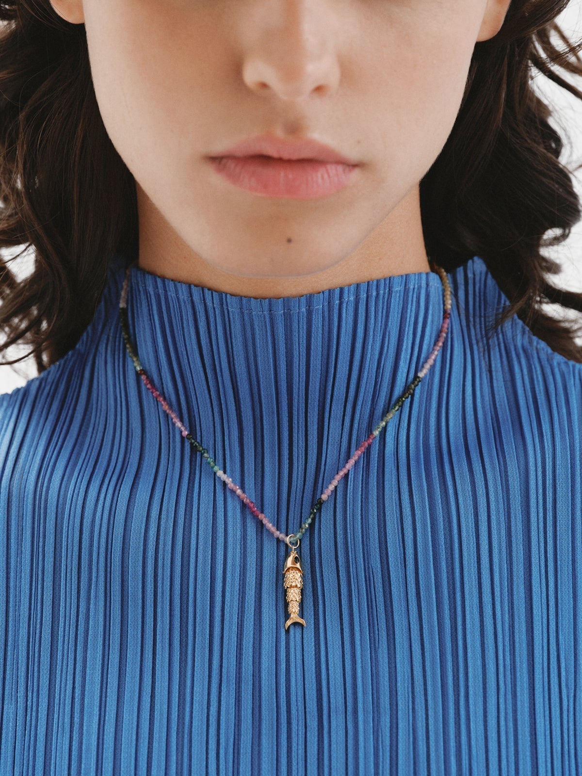 925 Silver charm bathed in 18K yellow gold with black enamel and fish shape.