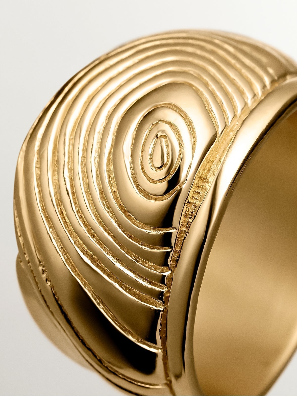 Wide 925 silver ring bathed in 18K yellow gold with embossed and irregular shape