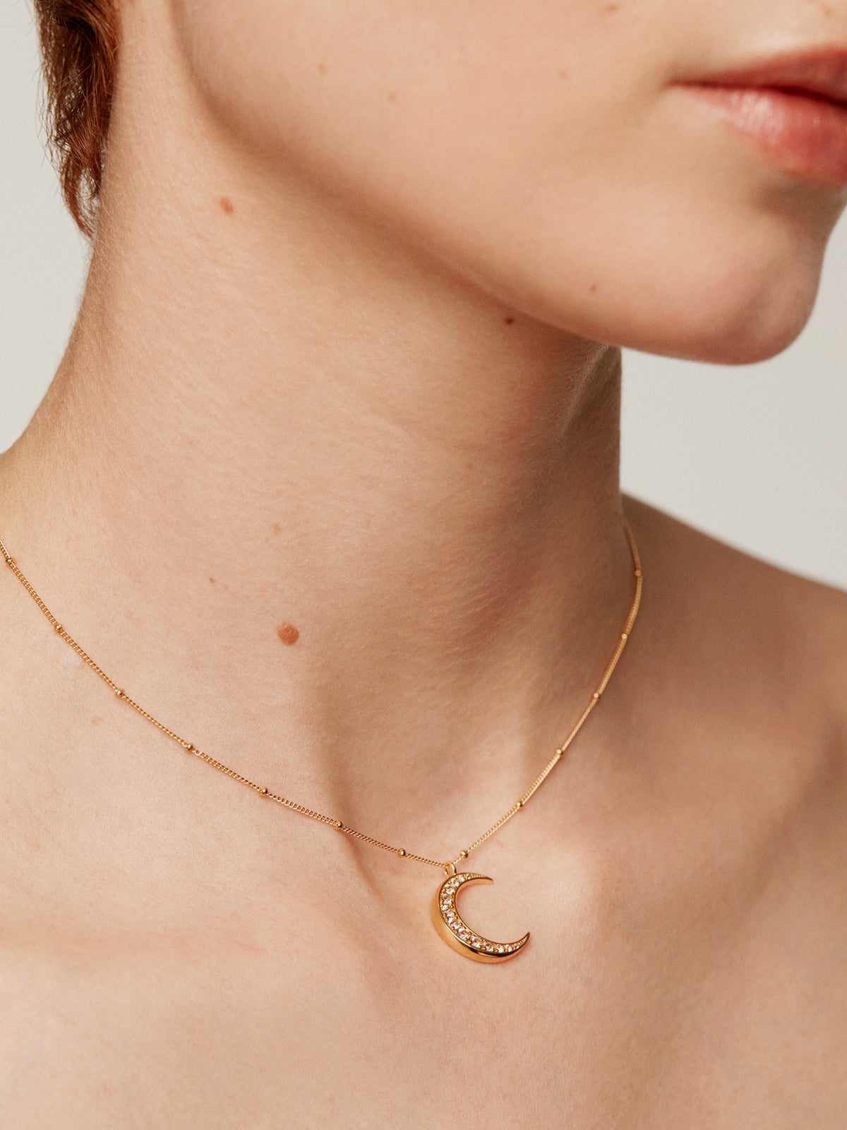 925 Silver pendant bathed in 18K yellow gold with a moon and white topazes.
