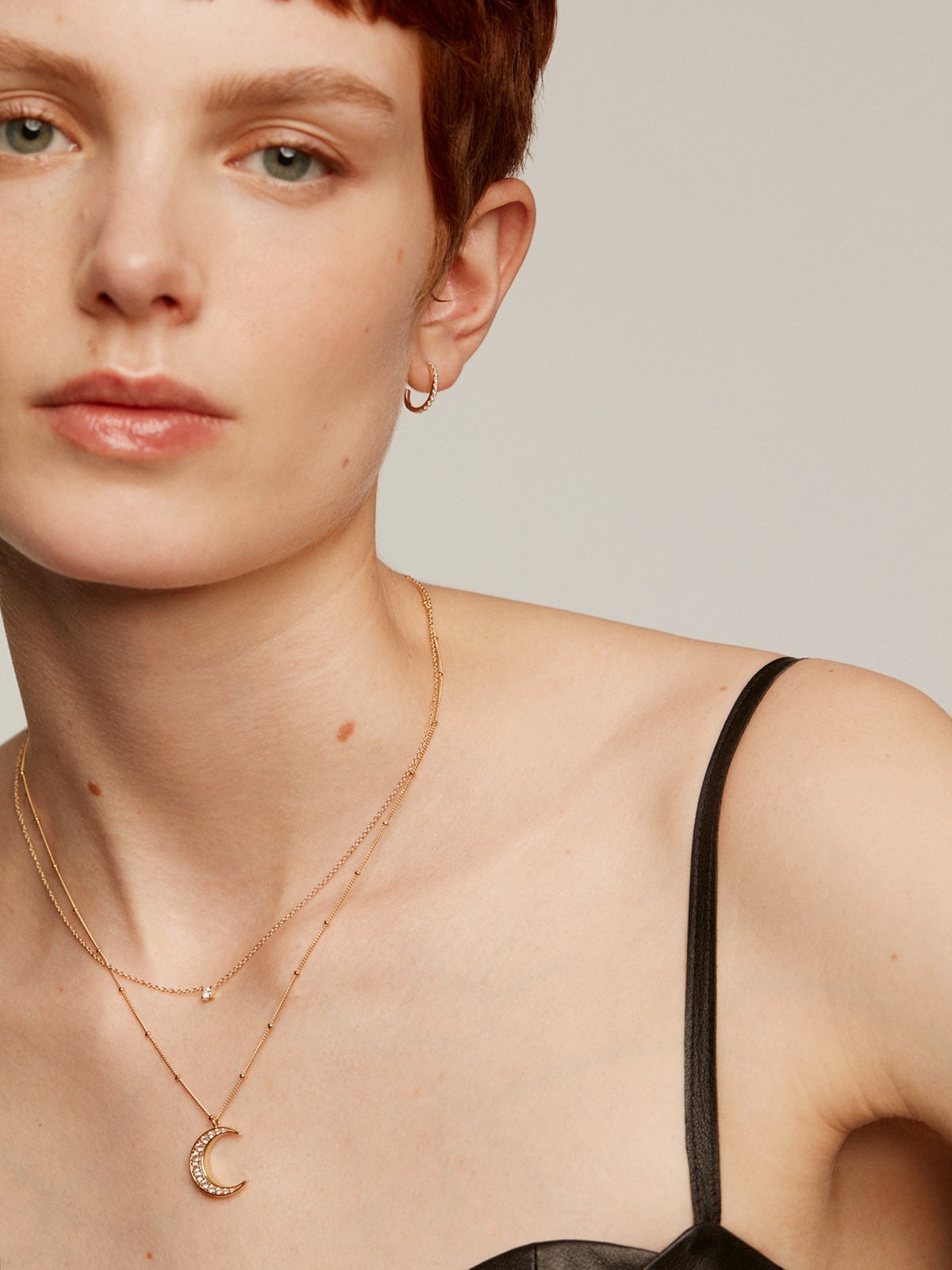 925 Silver pendant bathed in 18K yellow gold with a moon and white topazes.