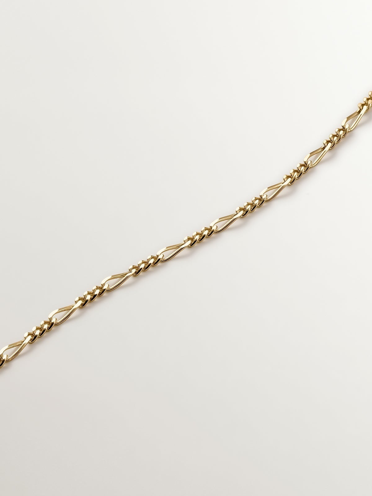 Fine Figaro link chain in 9K yellow gold