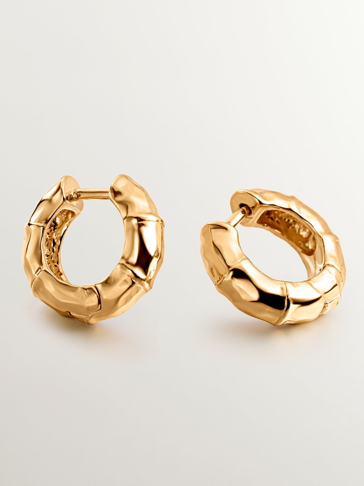 Small hoop earrings made of 925 silver, bathed in 18K yellow gold with a bamboo texture.