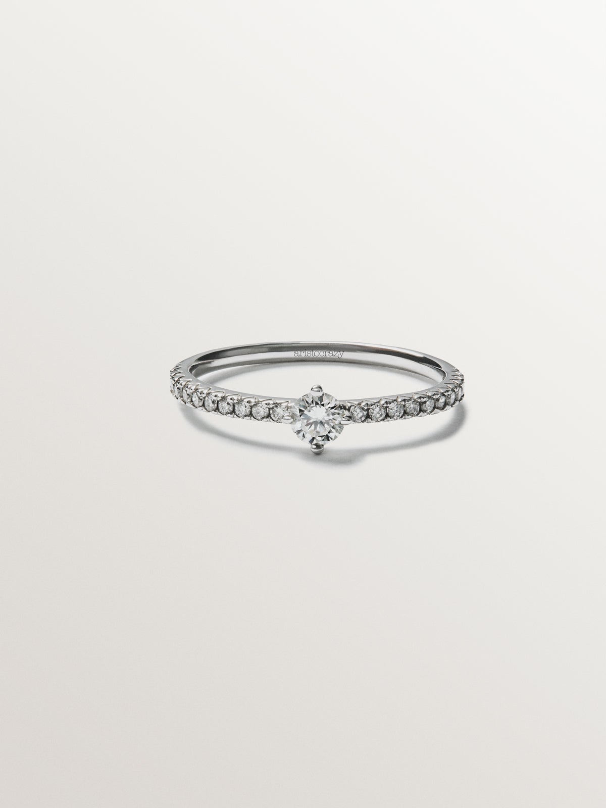 18K white gold ring with diamond arm and central diamond 0.23 cts