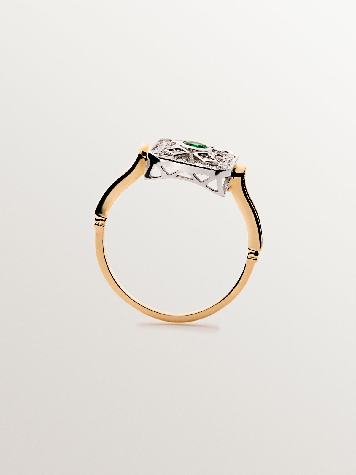 White gold and 18K yellow gold ring with emerald and brilliant-cut diamonds