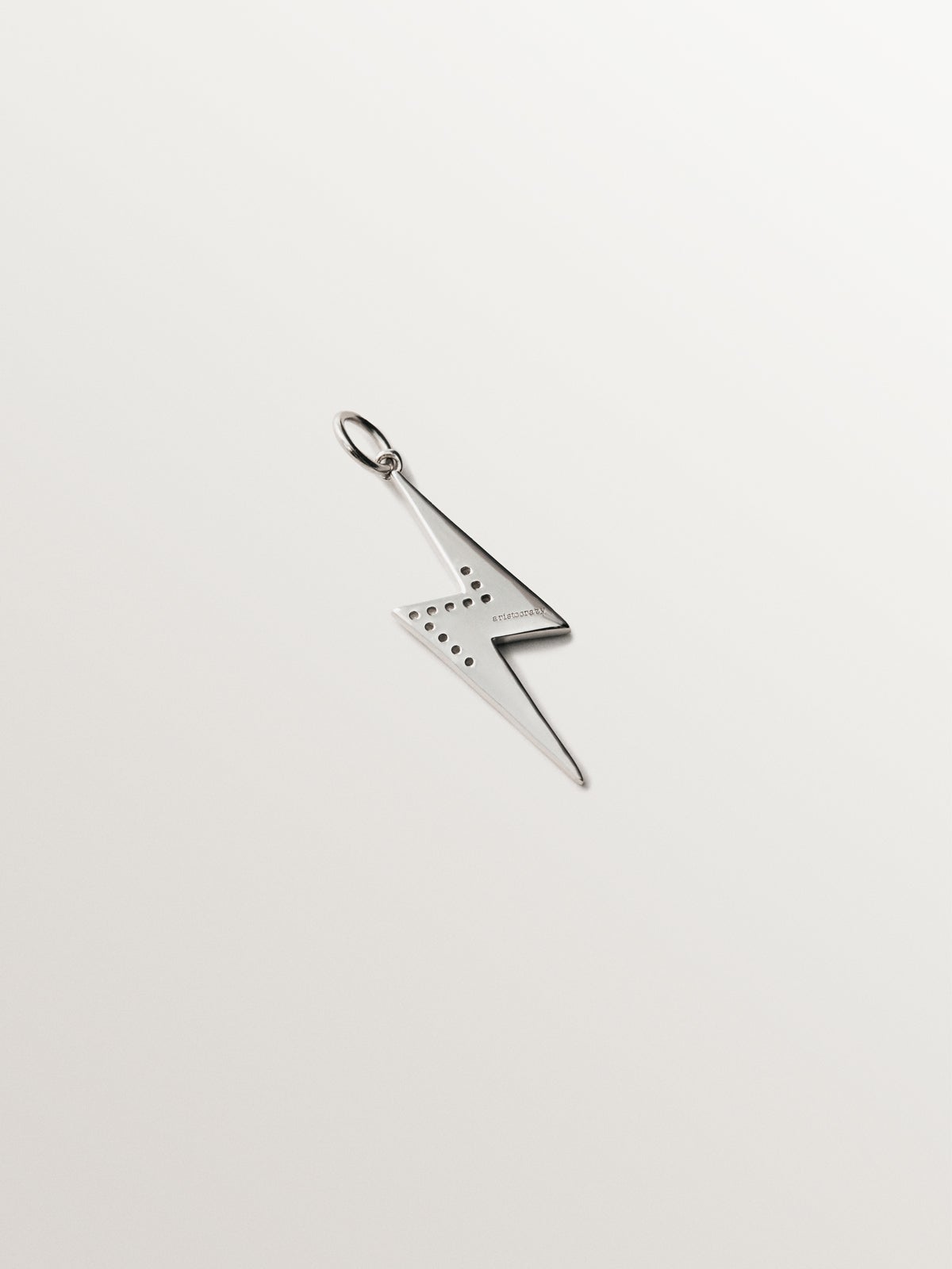 925 silver charm with white topaz and black enamel detail in the shape of a lightning bolt