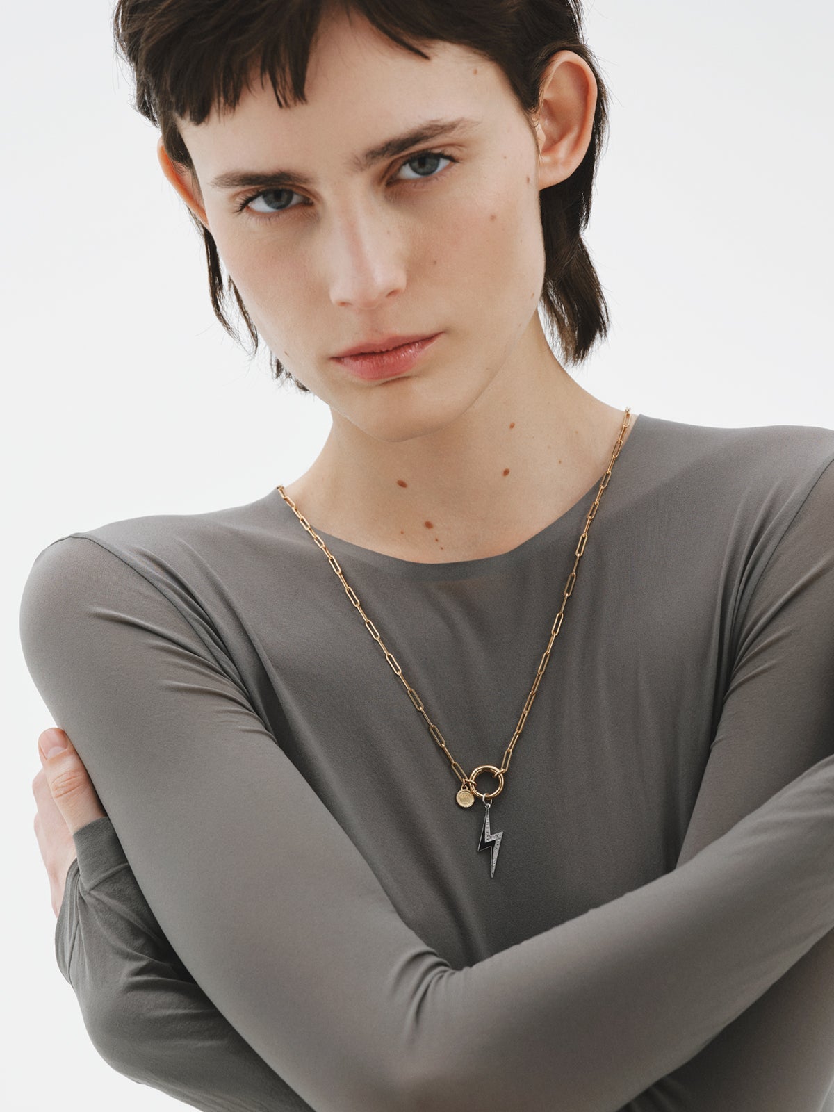 925 silver charm with white topaz and black enamel detail in the shape of a lightning bolt