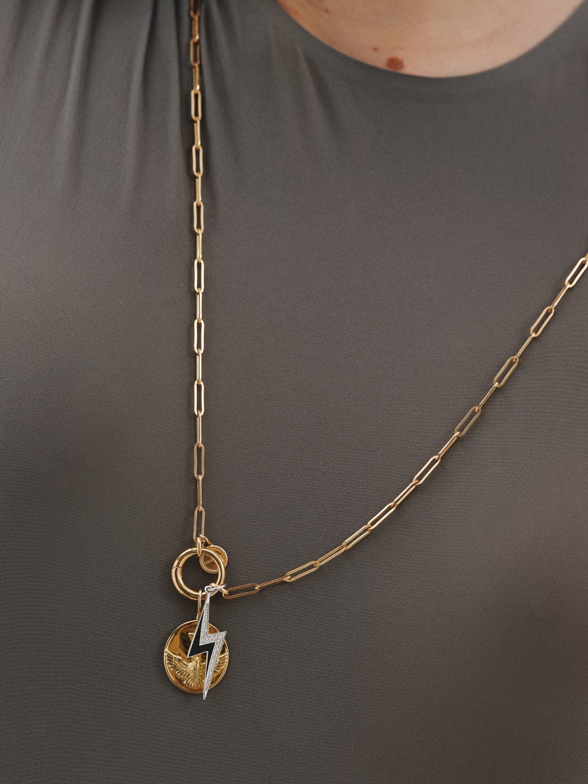925 silver charm with white topaz and black enamel detail in the shape of a lightning bolt