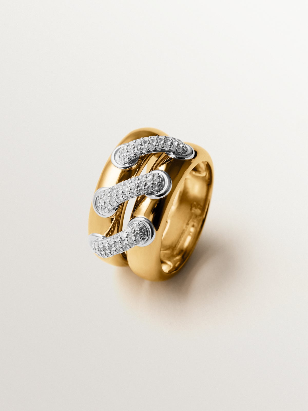 Double ring in 925 silver plated with rhodium and 18K yellow gold with white topaz pavé