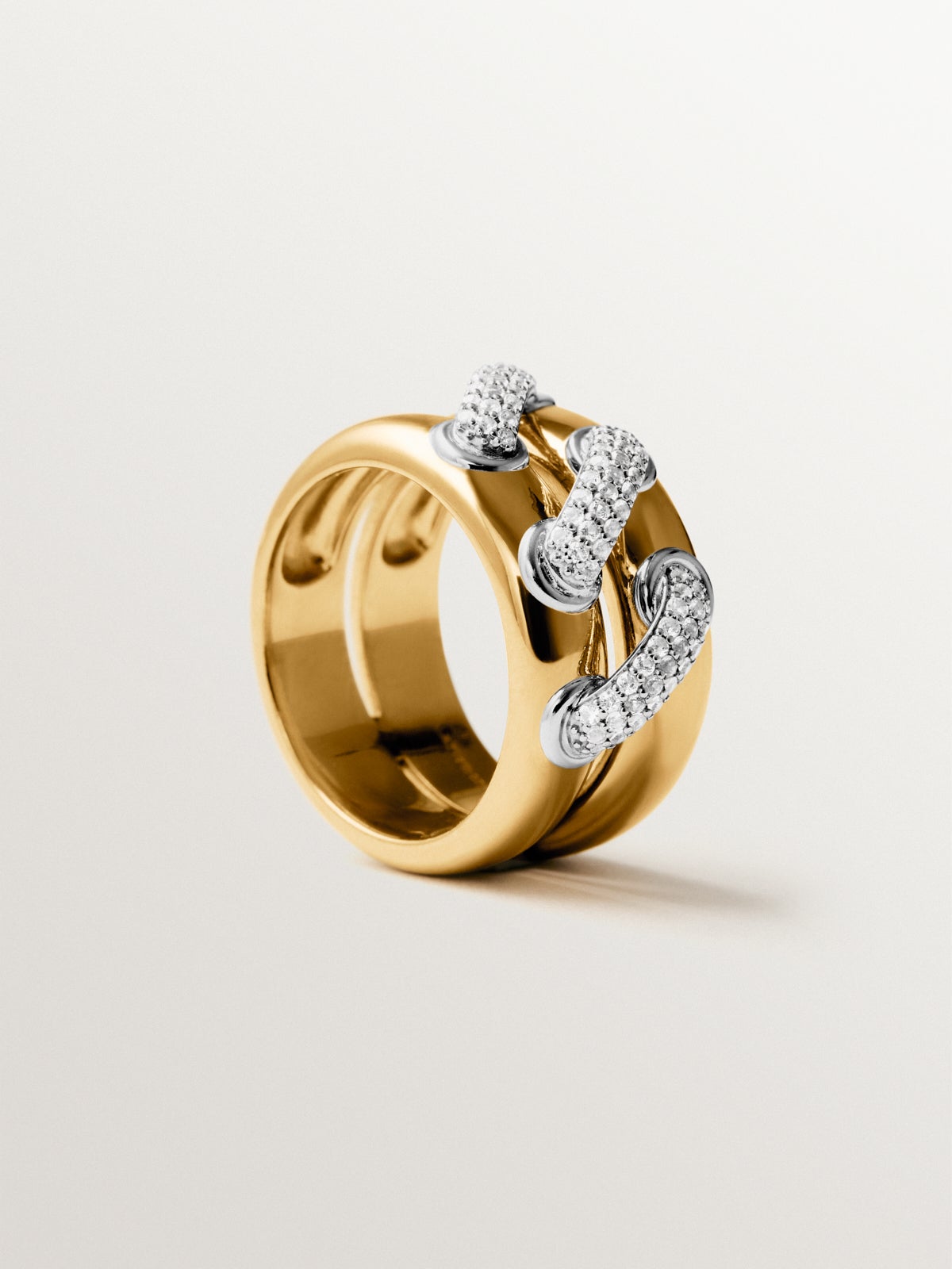 Double ring in 925 silver plated with rhodium and 18K yellow gold with white topaz pavé