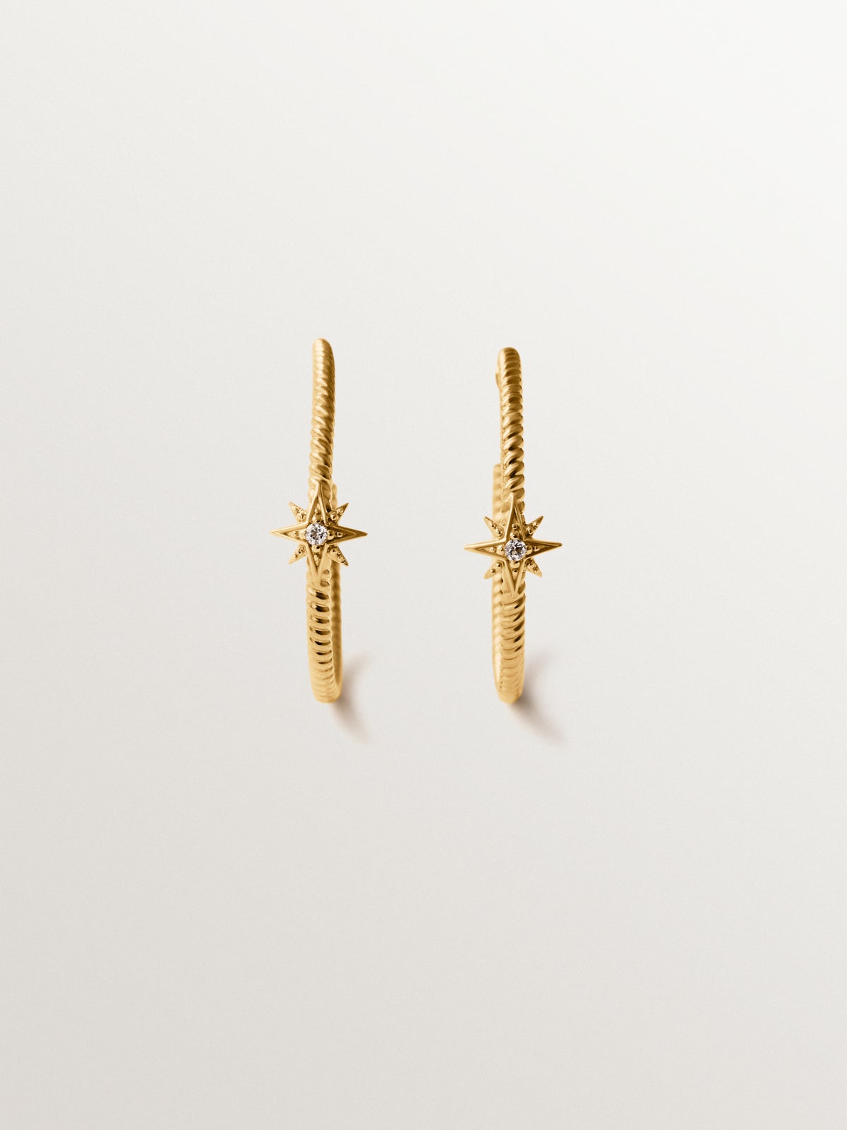Hoop earrings with galloned texture in 925 silver plated in 18K gold with white topaz and stars