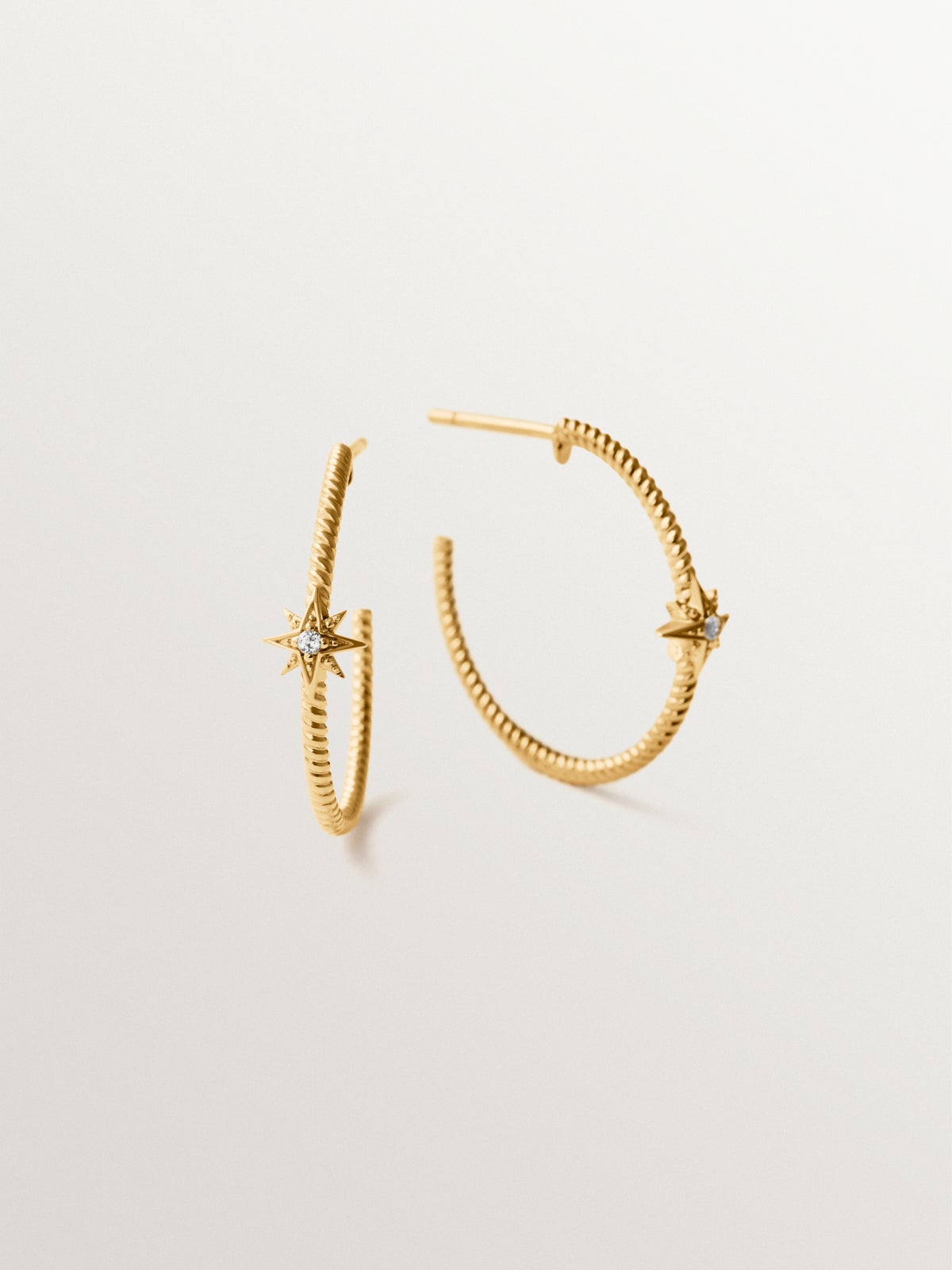 Hoop earrings with galloned texture in 925 silver plated in 18K gold with white topaz and stars