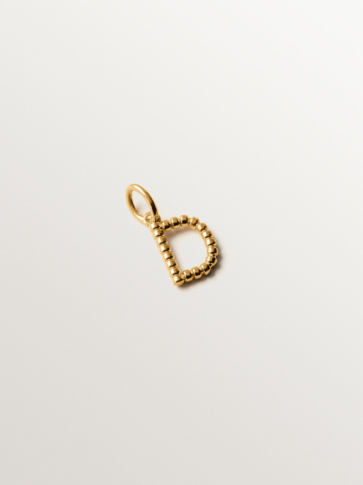 925 silver charm plated in 18K yellow gold with letter D and dial motifs