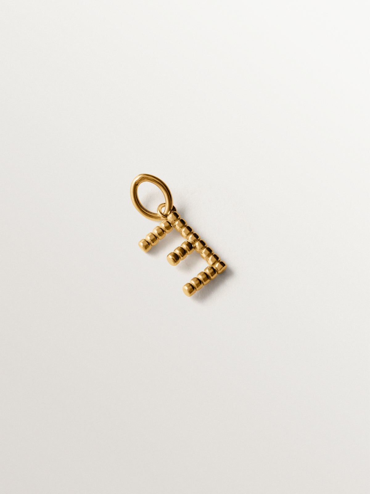 925 silver charm plated in 18K yellow gold with letter E and dial motifs