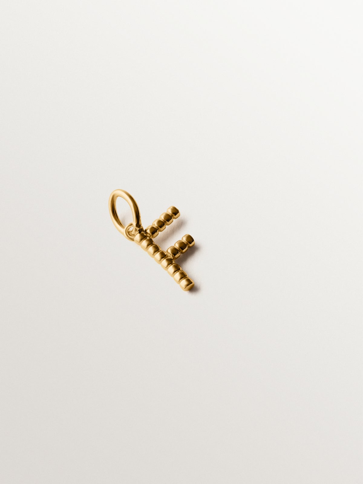 925 silver charm plated in 18K yellow gold with letter F and dial motifs