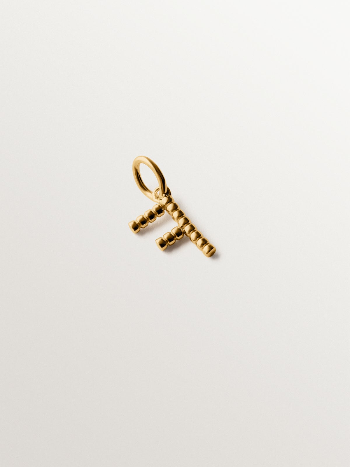 925 silver charm plated in 18K yellow gold with letter F and dial motifs