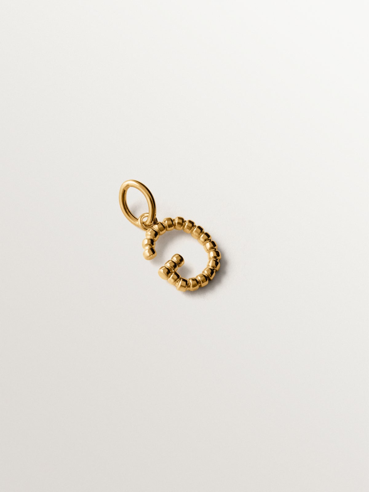 925 silver charm plated in 18K yellow gold with letter G and dial motifs