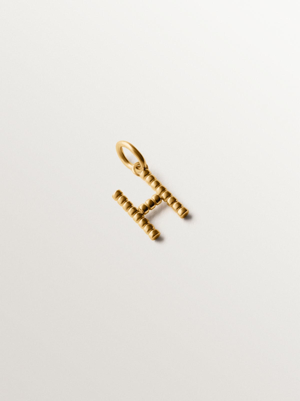 925 silver charm plated in 18K yellow gold with letter H and dial motifs