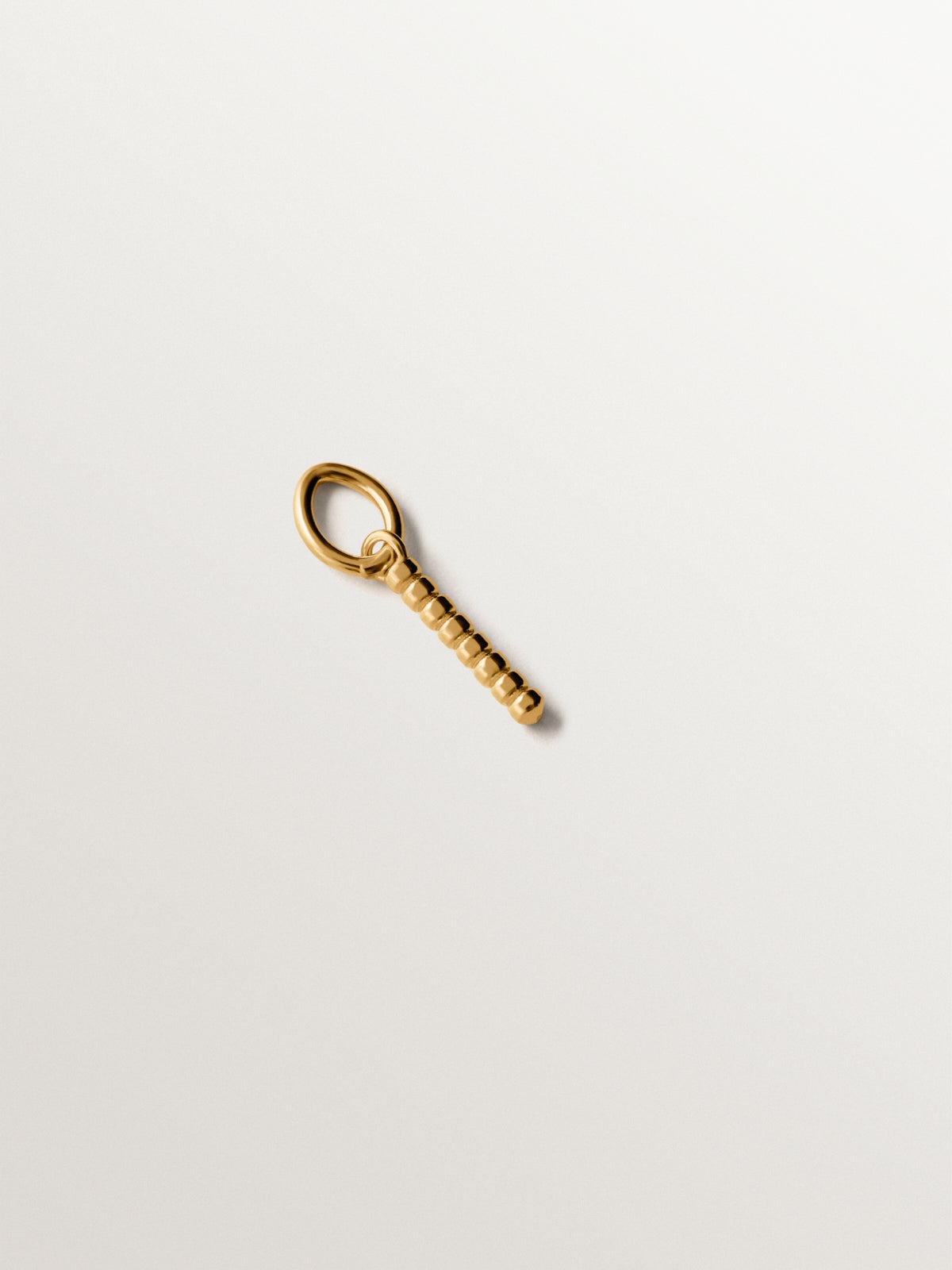 925 silver charm plated in 18K yellow gold with letter I and dial motifs