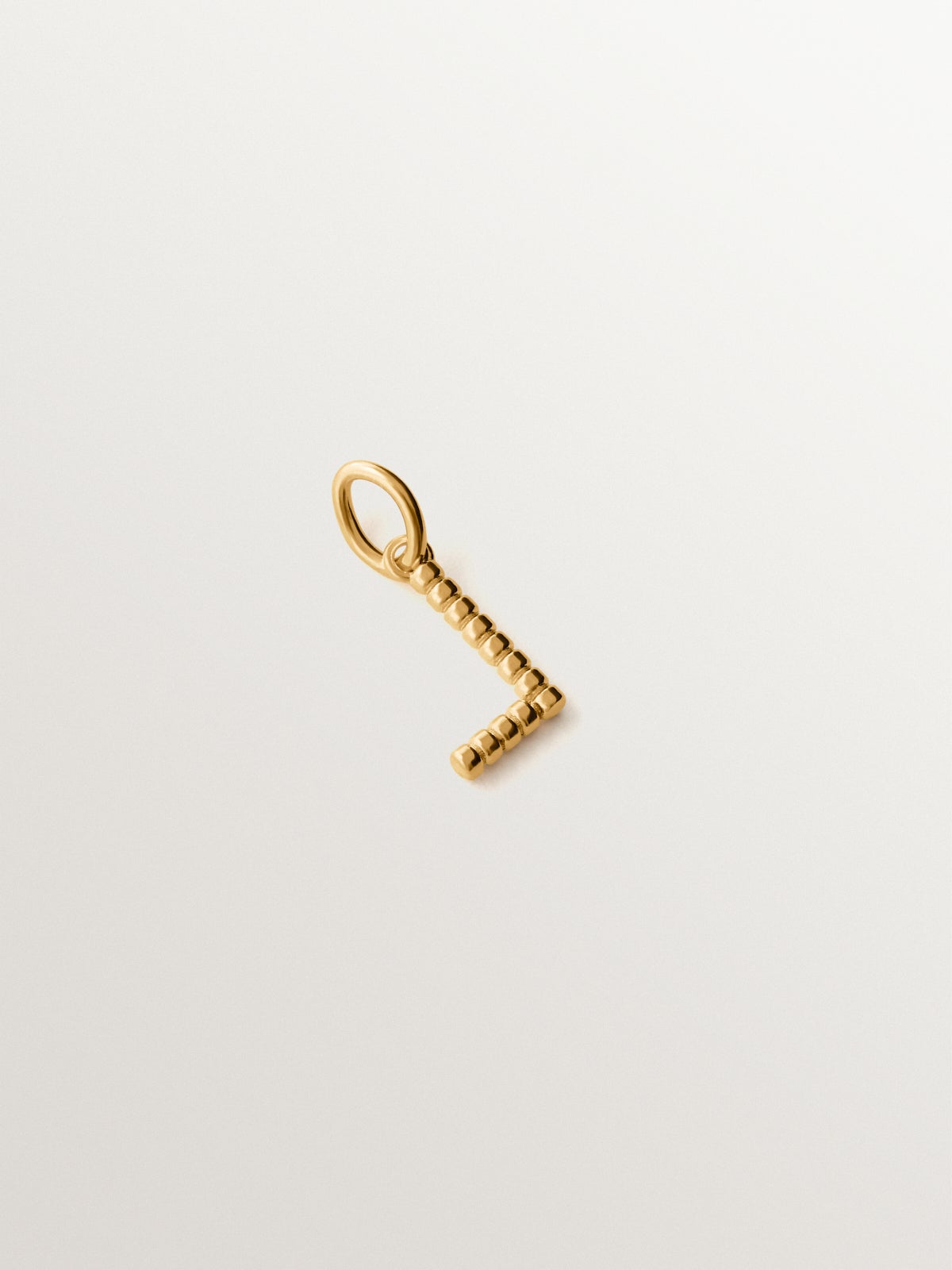 925 silver charm plated in 18K yellow gold with letter L and dial motifs