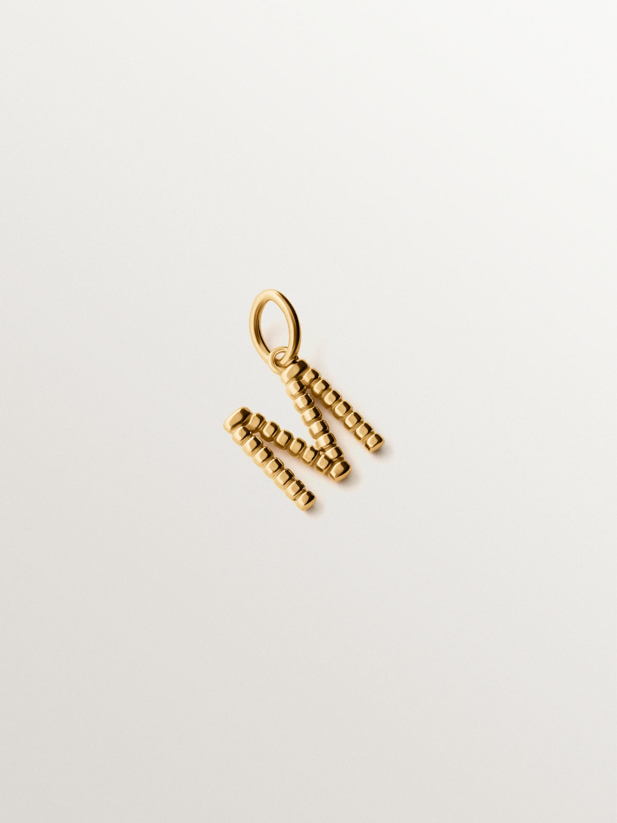925 silver charm plated in 18K yellow gold with letter M and dial motifs