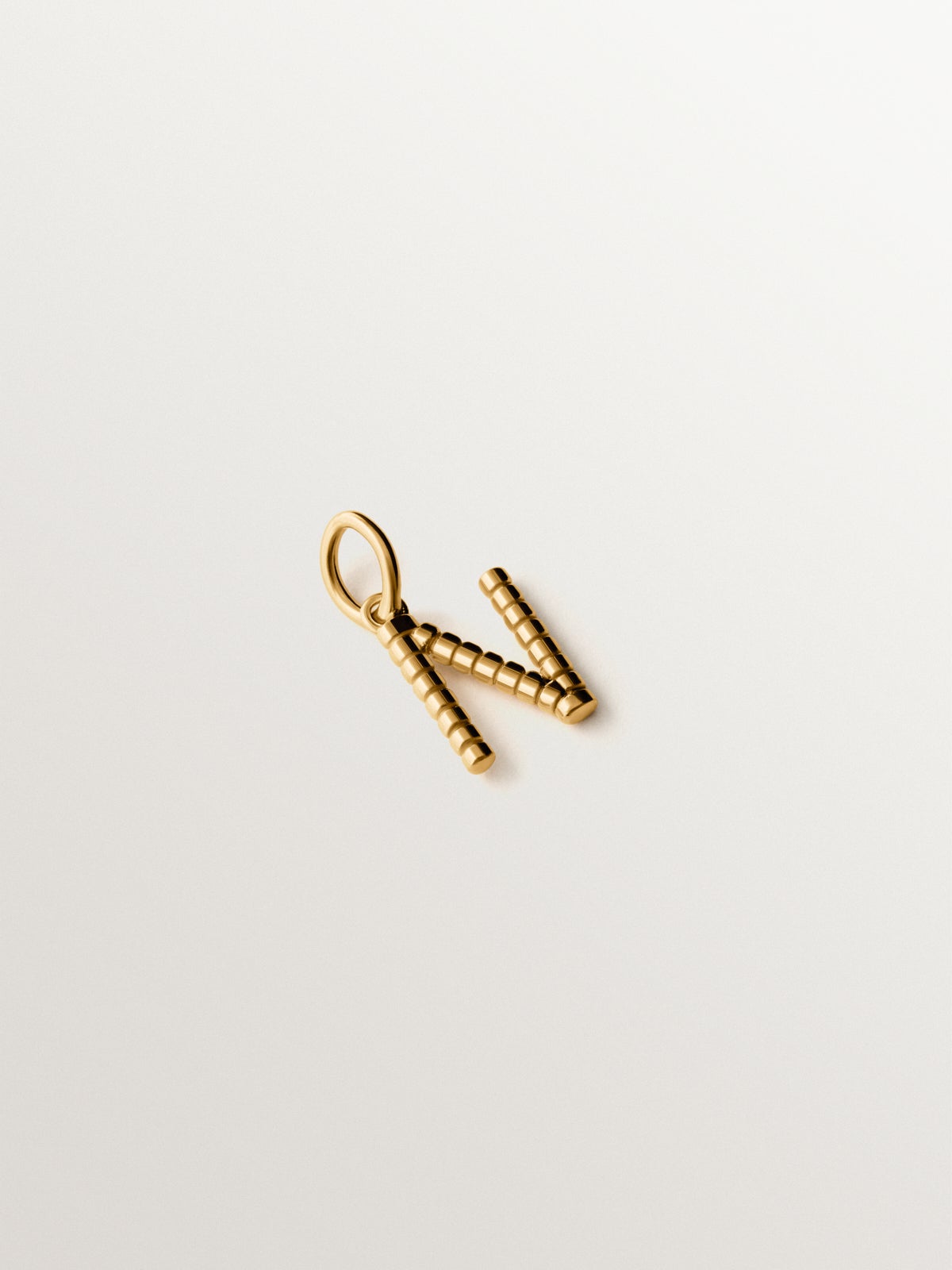 925 silver charm plated in 18K yellow gold with letter N and dial motifs