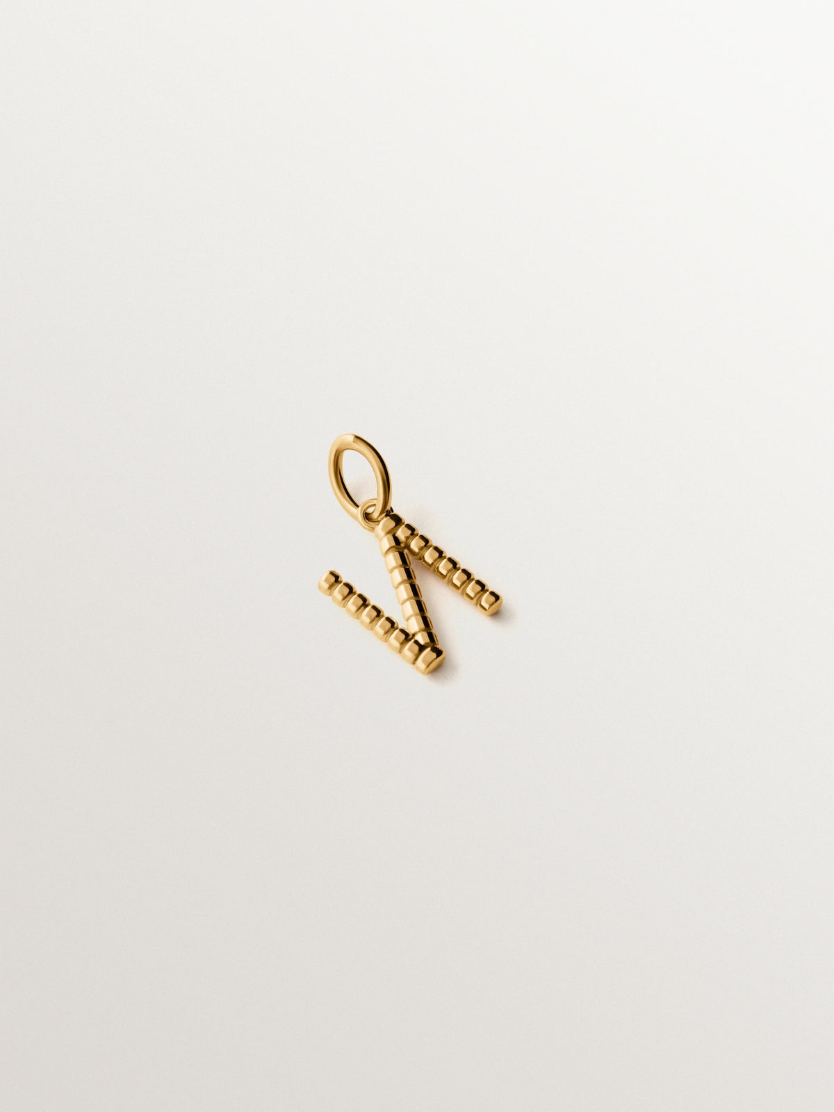 925 silver charm plated in 18K yellow gold with letter N and dial motifs