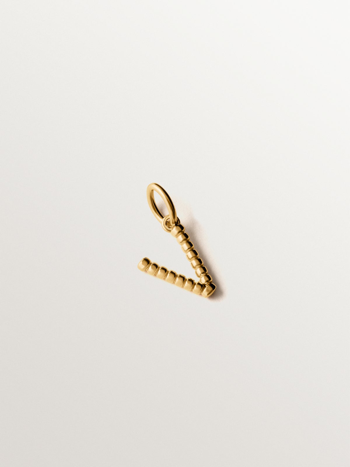 925 silver charm plated in 18K yellow gold with letter V and dial motifs