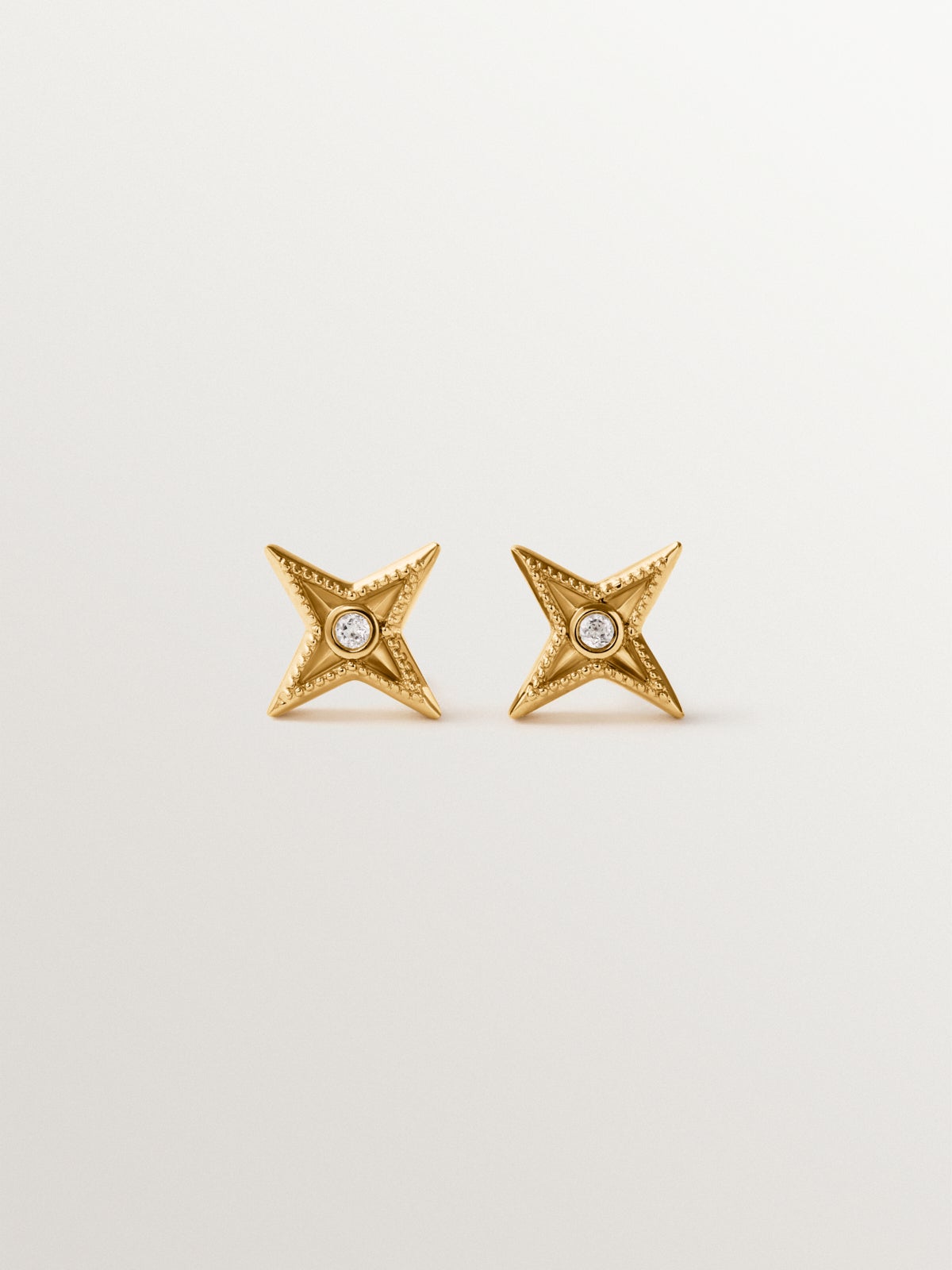 925 silver earrings plated in 18K yellow gold shaped like stars with white topaz