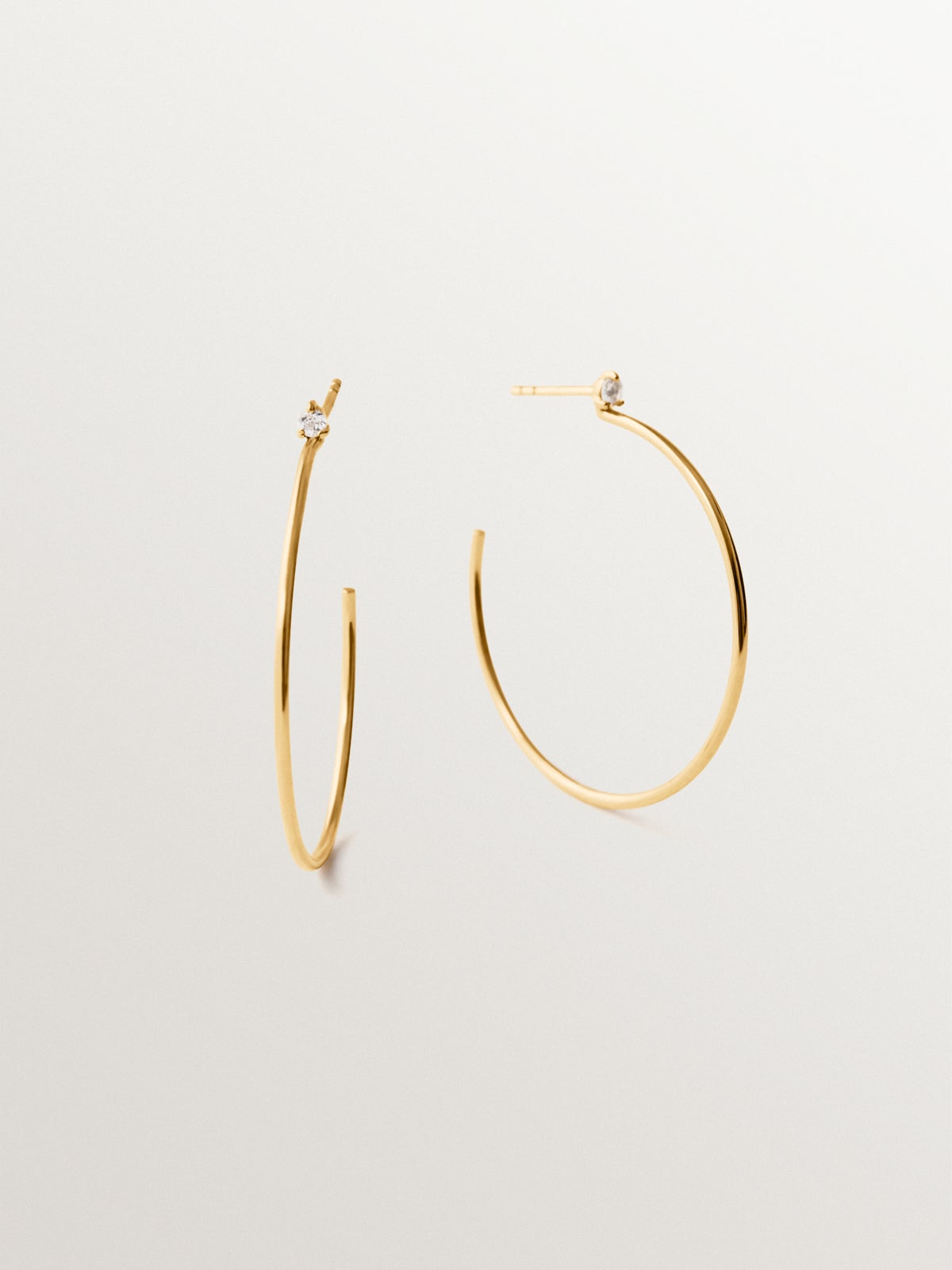 Large hoop earrings in 18K gold plated silver with white topaz
