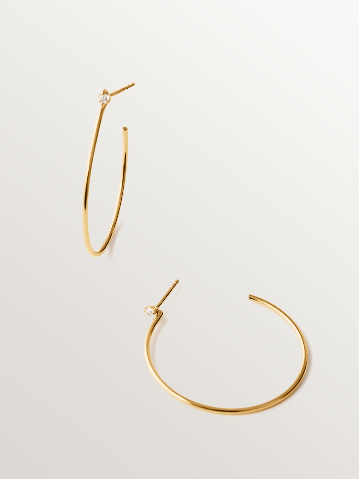 Large hoop earrings in 18K gold plated silver with white topaz