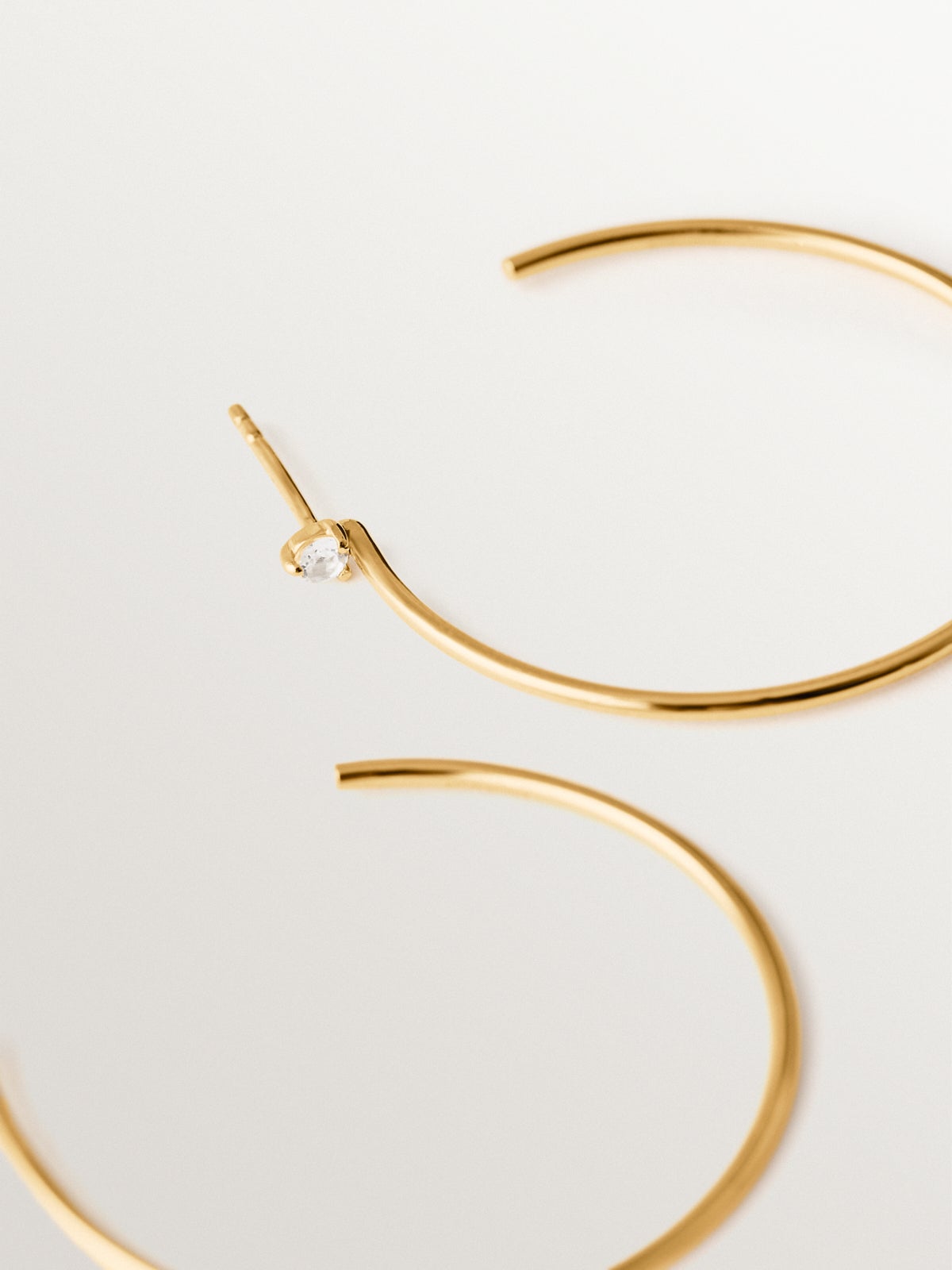 Large hoop earrings in 18K gold plated silver with white topaz