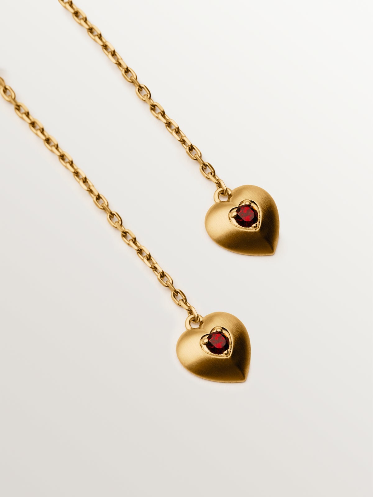 Long earrings in 18K yellow gold plated silver with red garnet beads, white topaz and heart shape