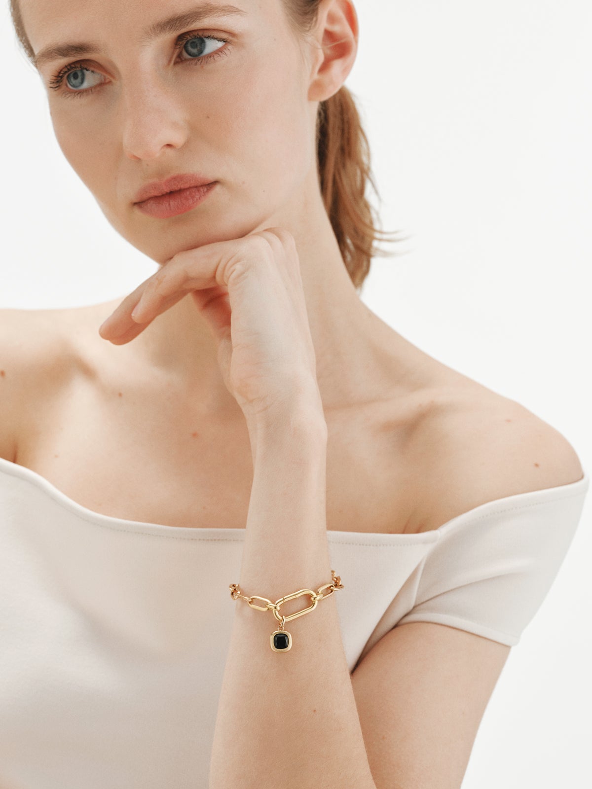 925 silver charm plated in 18K yellow gold with sky blue topaz