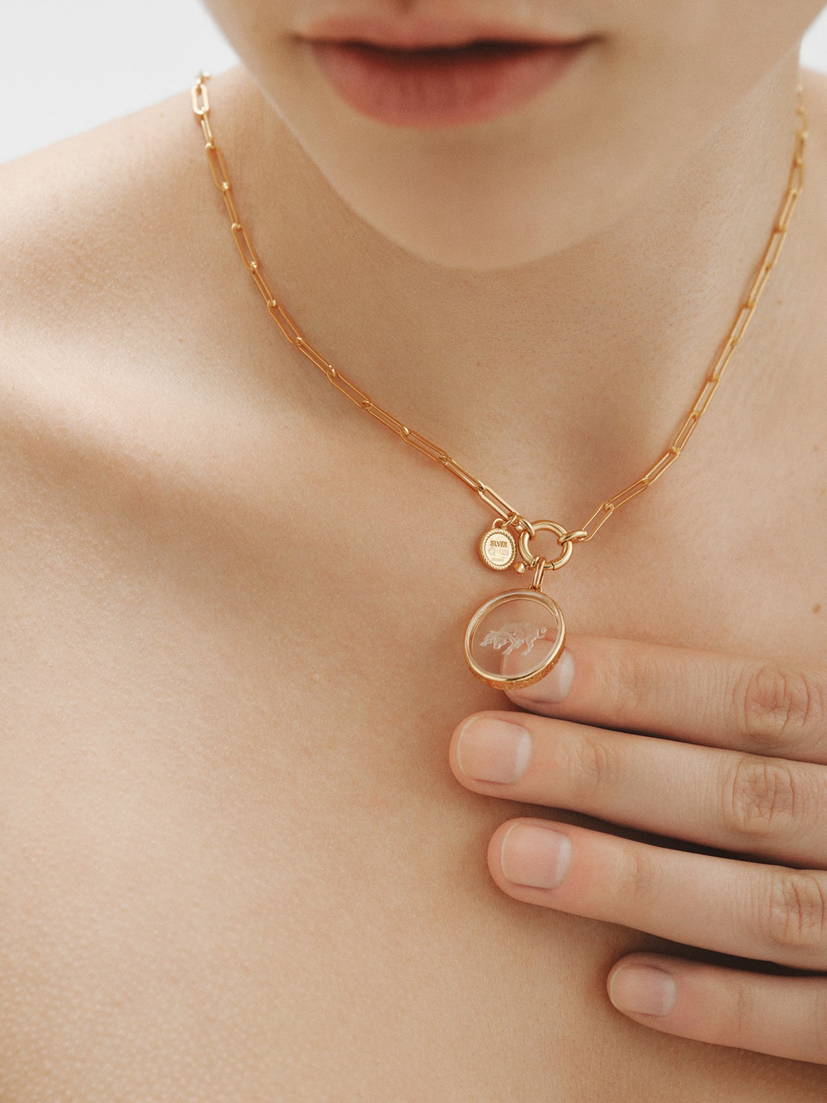 Tauro charm in 925 silver plated in 18K yellow gold and rock crystal