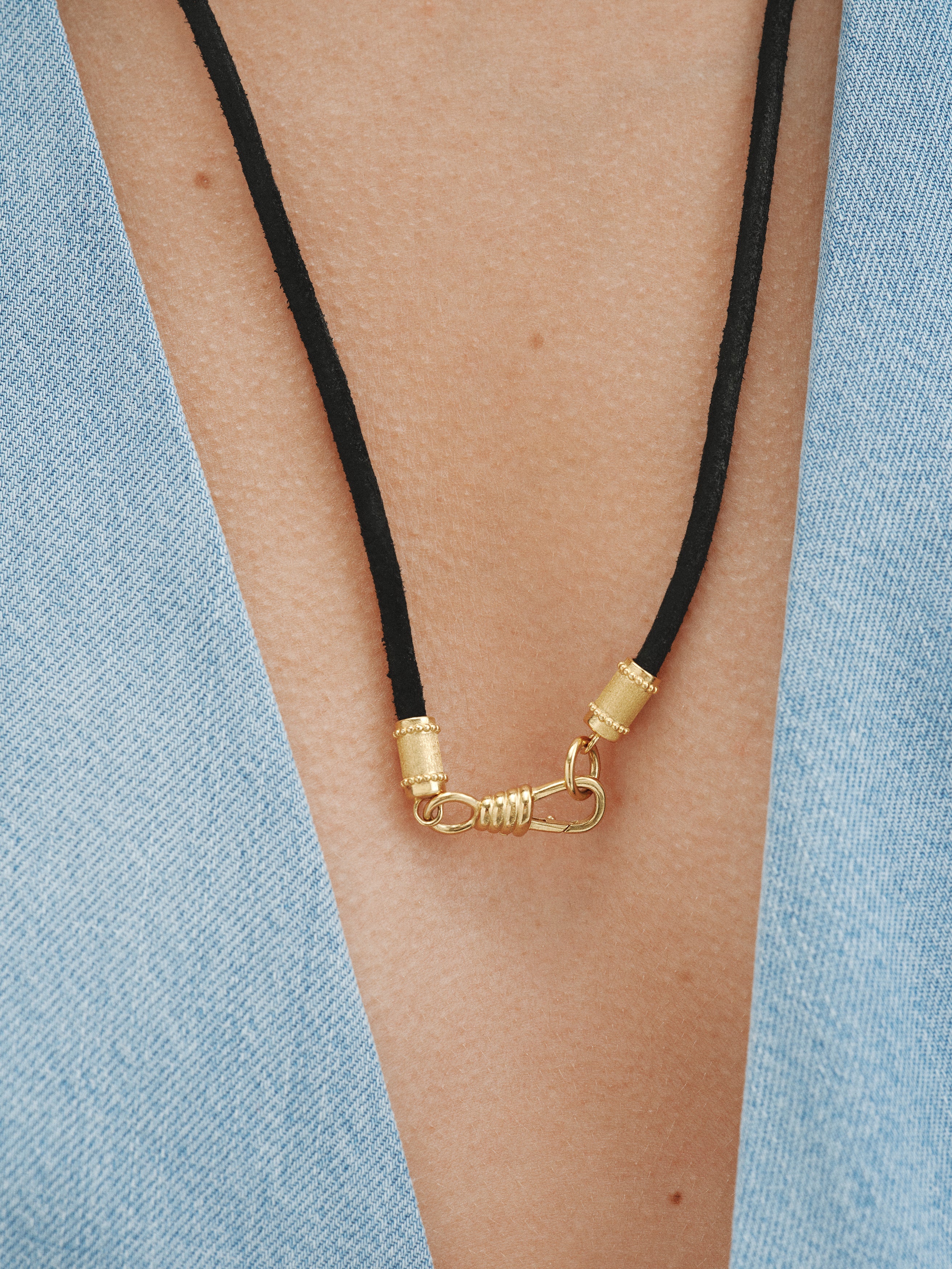 Plain black leather cord with 925 silver finishes plated in 18K yellow gold