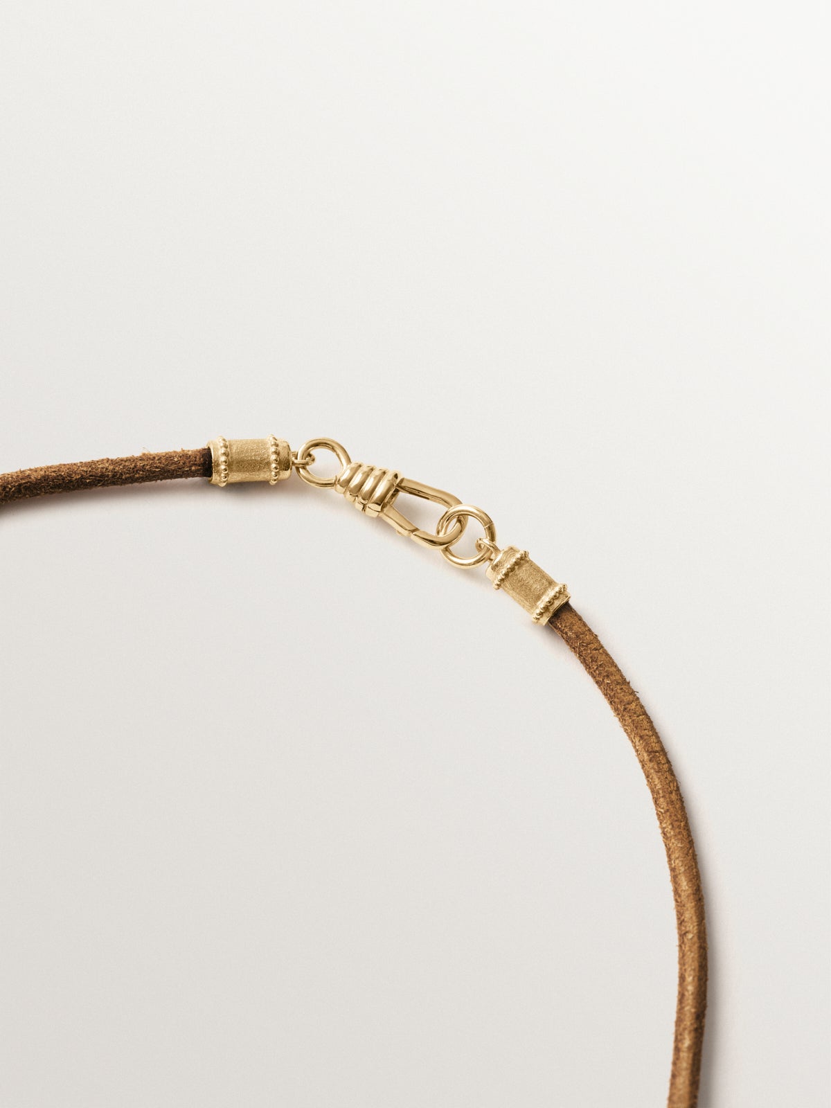 Smooth brown leather twine with 925 silver finishes plated in 18K yellow gold