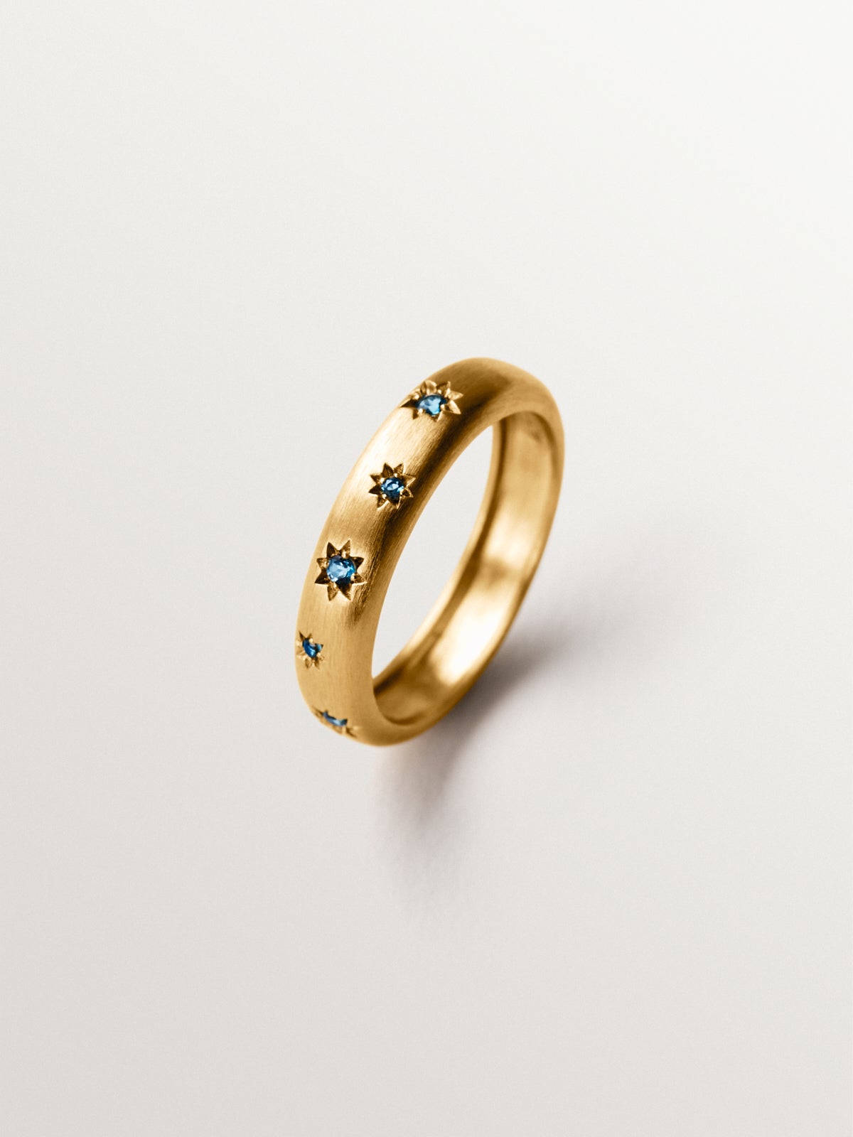 925 silver ring plated in 18K yellow gold with blue topaz