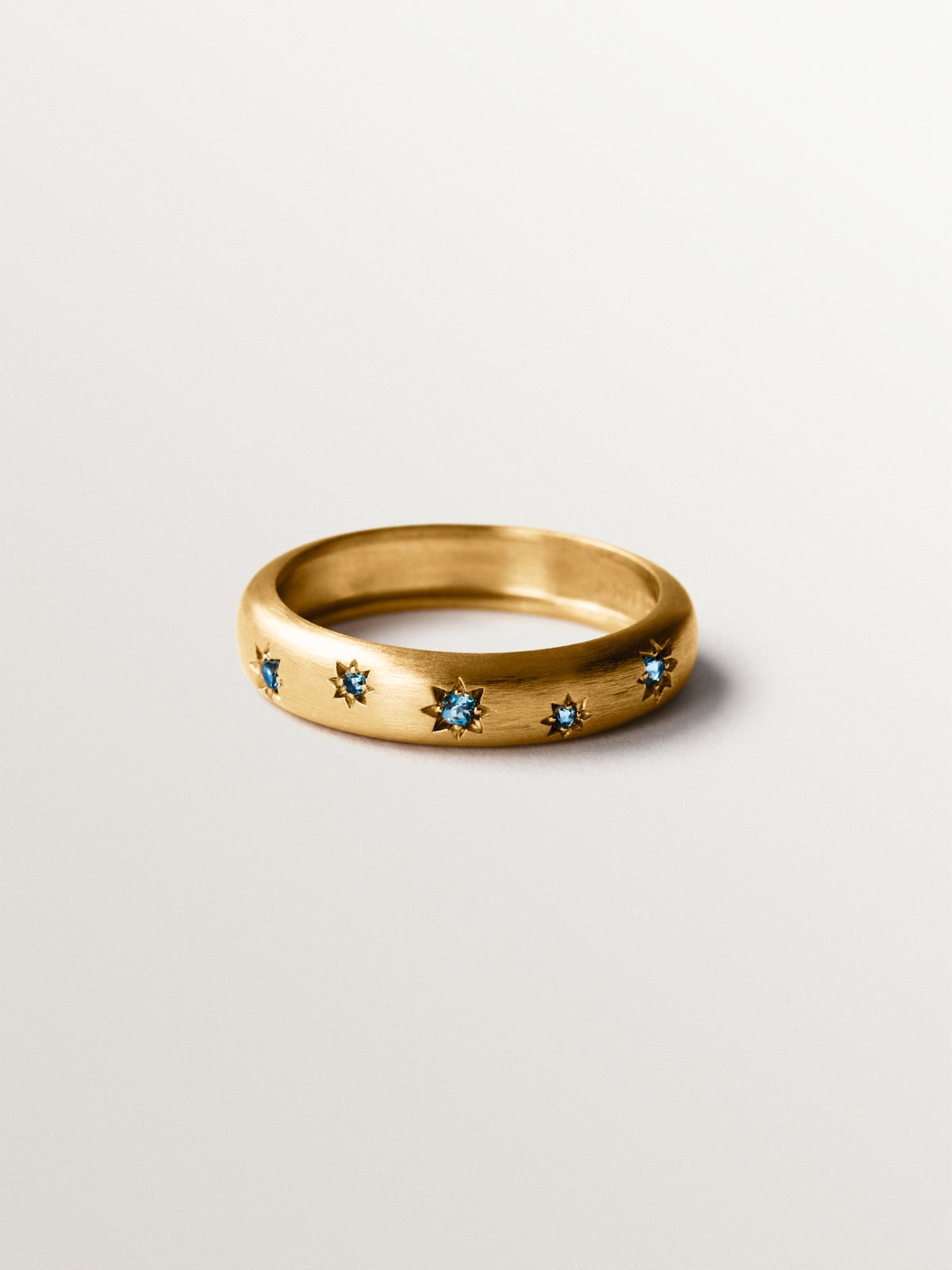 925 silver ring plated in 18K yellow gold with blue topaz