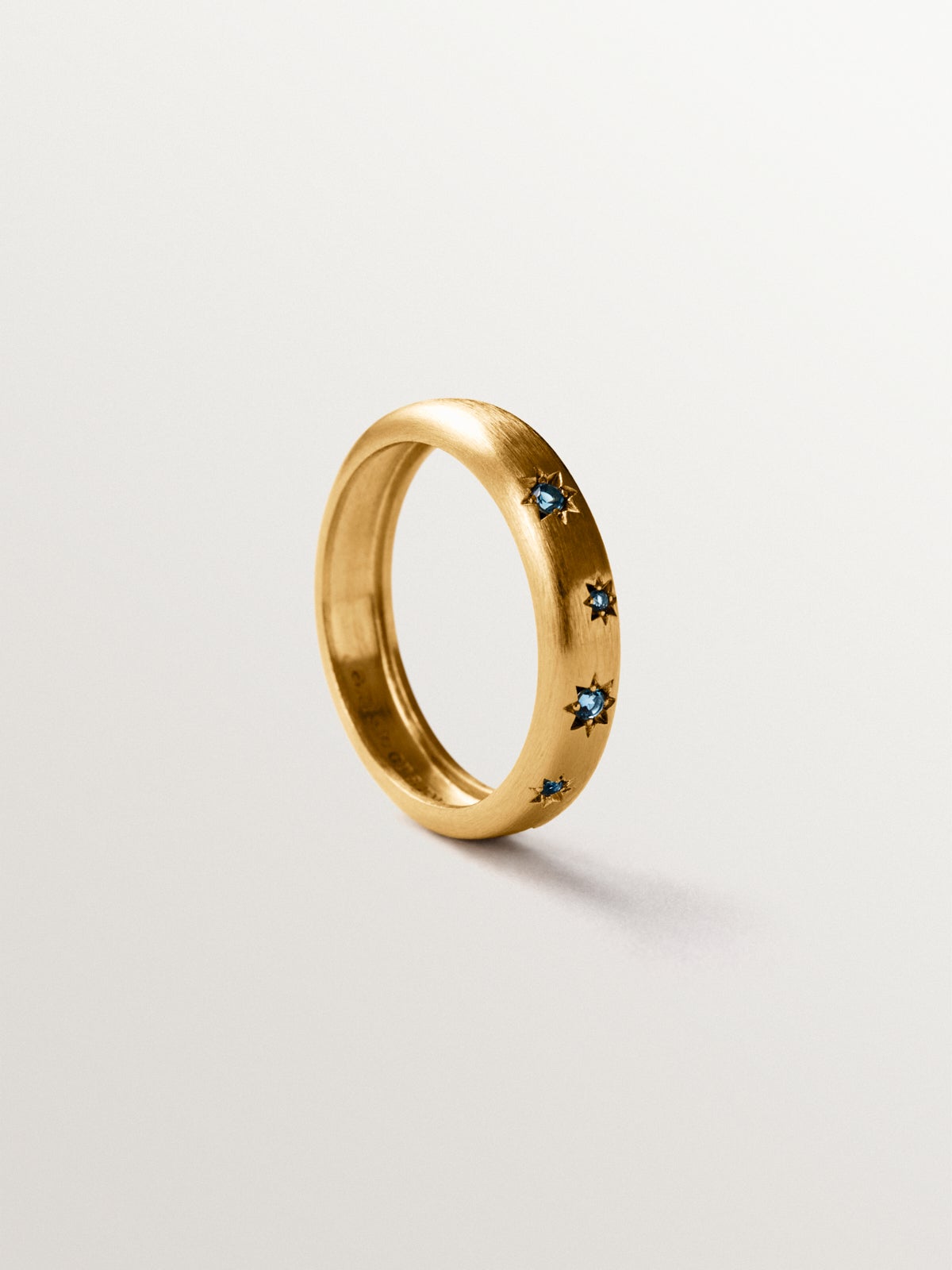 925 silver ring plated in 18K yellow gold with blue topaz