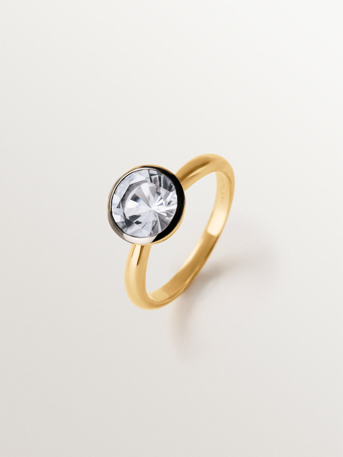 Two-tone 925 silver ring plated in 18K yellow gold with white topaz