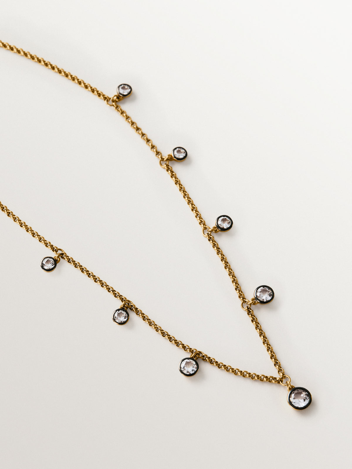 Two-tone necklace in 925 silver plated in 18K yellow gold with white topaz