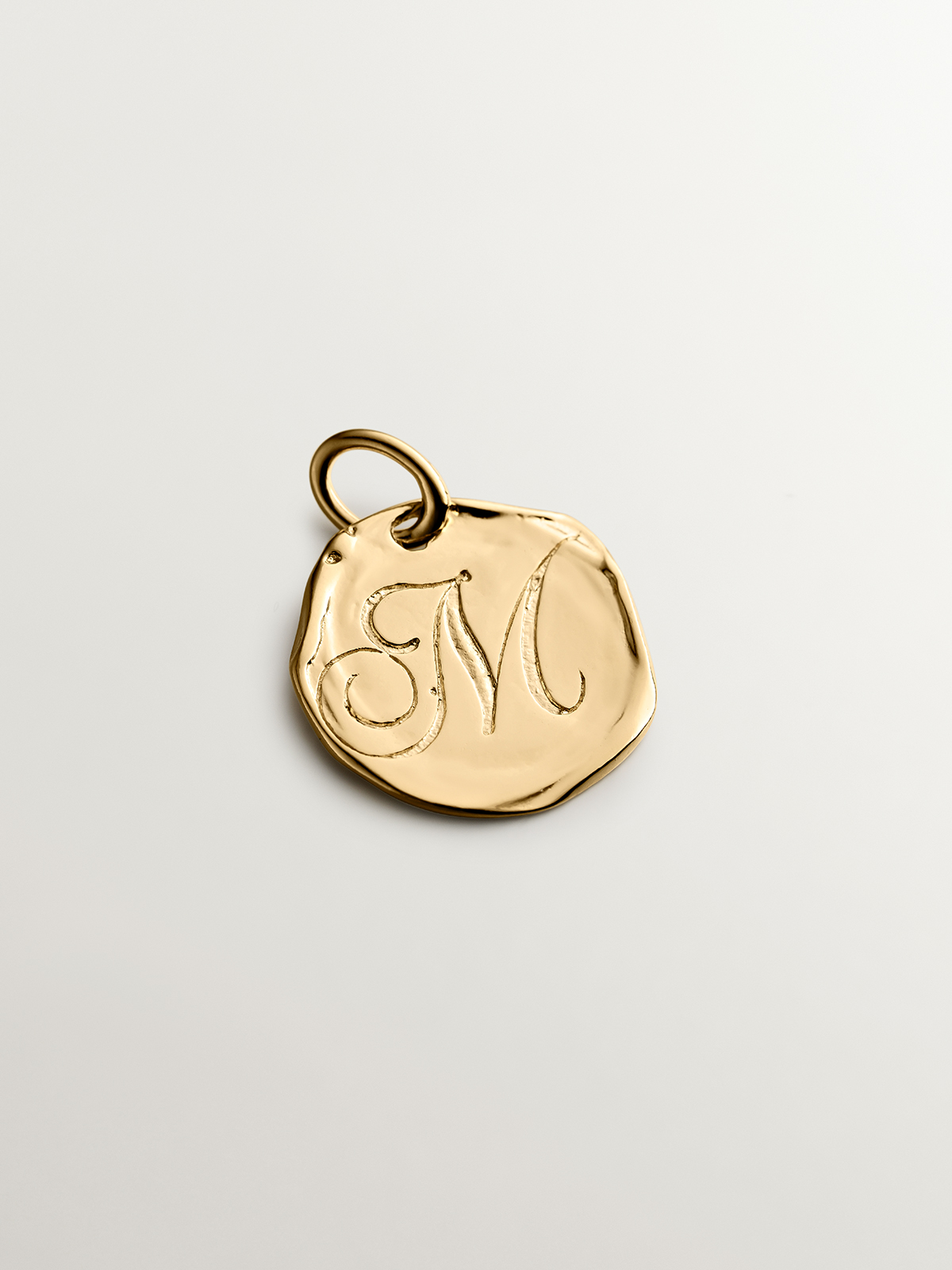 Handcrafted charm made of 925 silver bathed in 18K yellow gold with initial M.